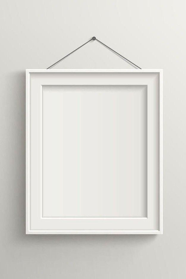 an empty white frame hanging on the wall