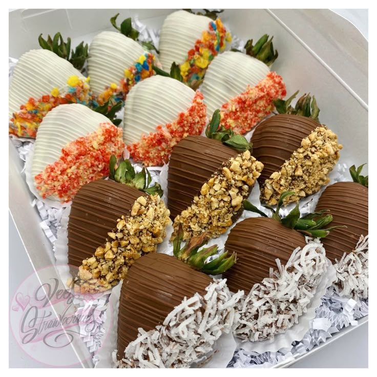 chocolate covered strawberries in a box with sprinkles and flowers on top