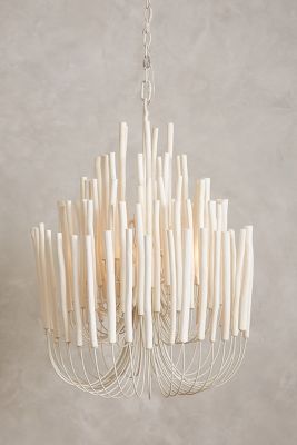 a white chandelier hanging from a chain with sticks sticking out of the bottom