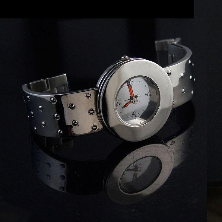 Unisex, Goth futuristic watch. Model name - PLAIN MIRROR Watch case stainless steel. Watch back stainless steel. Strap stainless steel. Length of watch case is 44mm, 1 6/8 inches. Diameter of the watch face is 35mm, 1 3/8 inches. With of strap is 22mm, 7/8 inches. Miyota quarts movement. Hi Tek graphics on the watch face. Modern Watch Accessories With Stainless Steel Clasp, Gift Stainless Steel Watch Accessories With Metal Dial, Modern Metal Watch Accessories For Gifts, Silver Stainless Steel Watch Accessories With Analog Display, Modern Stainless Steel Watch Accessories For Gifts, Modern Metal Analog Watch Accessories, Modern Analog Metal Watch Accessories, Stainless Steel Analog Watch As A Gift, Metal Analog Watch Accessories As Gifts