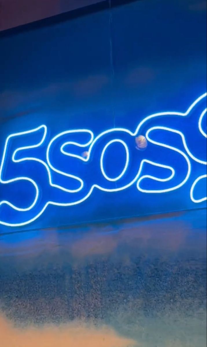 a neon sign that reads 350s on the side of a building