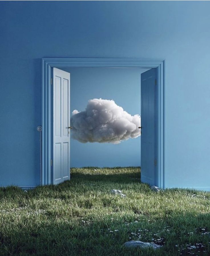 an open door with a cloud floating in the sky above it on top of green grass