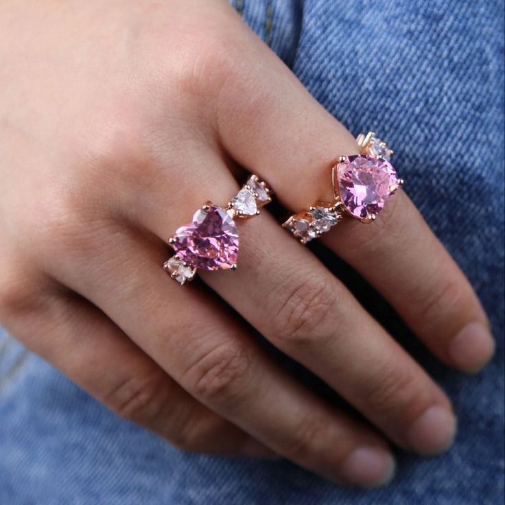 Get the wifey ring, no engagement required! Heart-shaped pink crystal center stone Channel-set emerald cut crystals on shank 18K Rose Gold-plated over sterling silver Pink and clear zircon diamonds Shop our velvet hexagon ring boxes HERE. Also featured: Nsozi Jumbo Crystal Hoops and Sequin Facemask ℹ Don't see your size? Message us and we will be happy to help