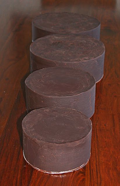 three round cake pans sitting on top of a wooden table