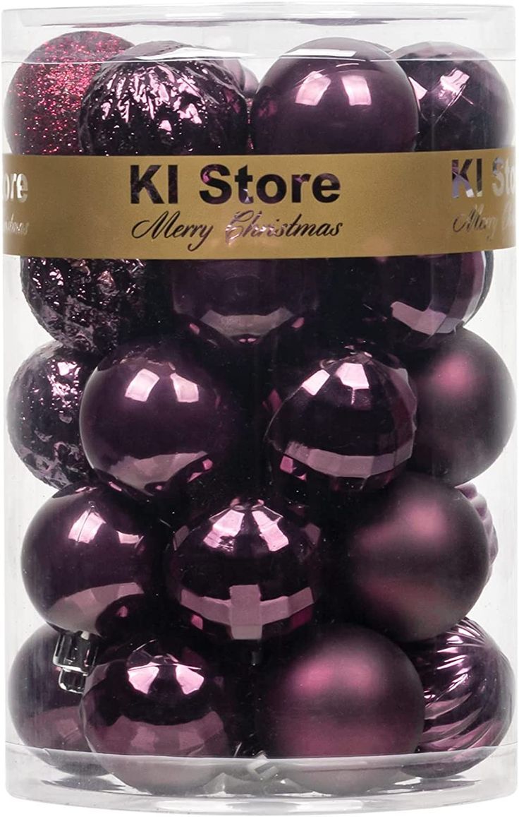 purple christmas balls in a clear box with a gold ribbon around the top and bottom