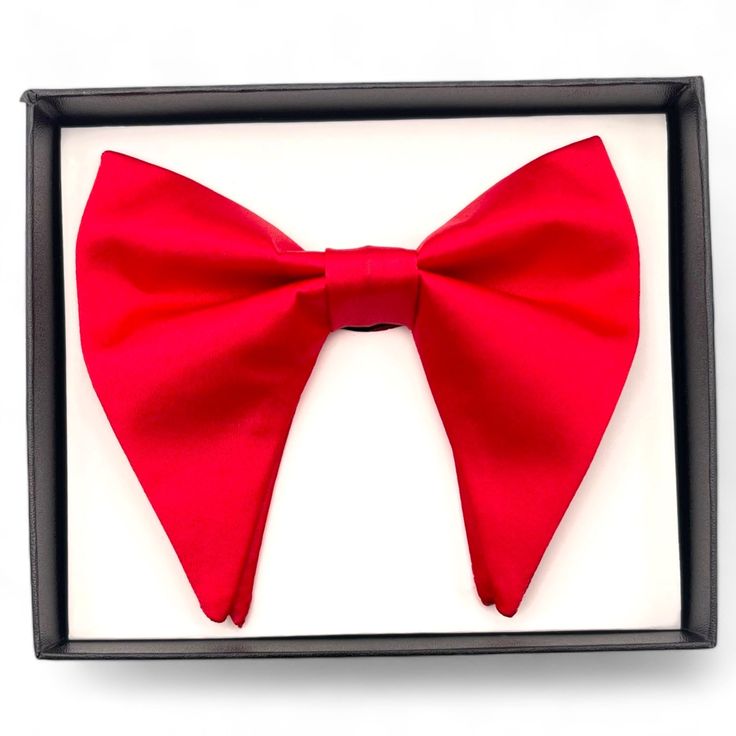 Oversized Butterfly Bow Tie Stand out with this oversized butterfly bow tie, a bold take on the classic design. Perfect for those looking to make a statement, it adjusts to fit neck sizes from 14 to 21 inches, making it versatile for any formal or semi-formal occasion. Materials: 100% Polyester Handpicked & Organized By Augustino Luxe Elegant Solid Color Bow With Tie Back, Solid Color Bow Tie For Party, Elegant Solid Color Bow, Solid Color Party Bow With Ties, Elegant Red Bow Tie As Gift, Classic Bow With Bow Tie Back For Party, Classic Party Bow With Tie Back, Dapper Solid Color Party Ties, Chic Detachable Bow Tie For Black Tie Events