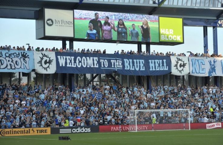 a soccer stadium filled with lots of people and banners that read welcome to the blue hell