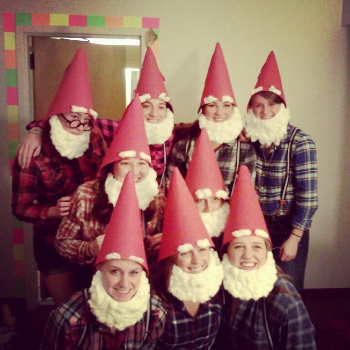 a group of people wearing red and white gnome hats