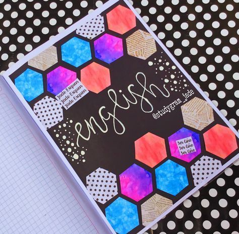 an open notebook with writing on it sitting on top of a polka dot covered table