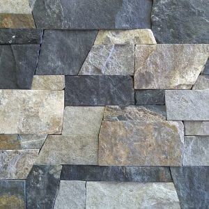 a stone wall made up of several different types of rocks and stones, all in various colors