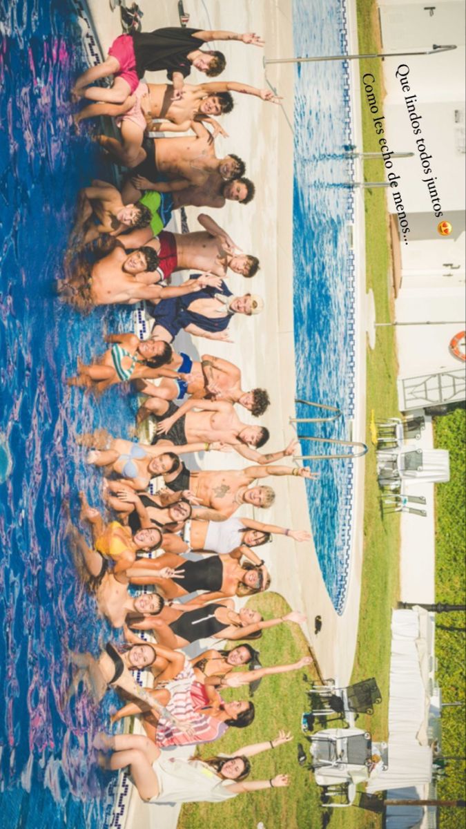 a group of people standing in front of a swimming pool