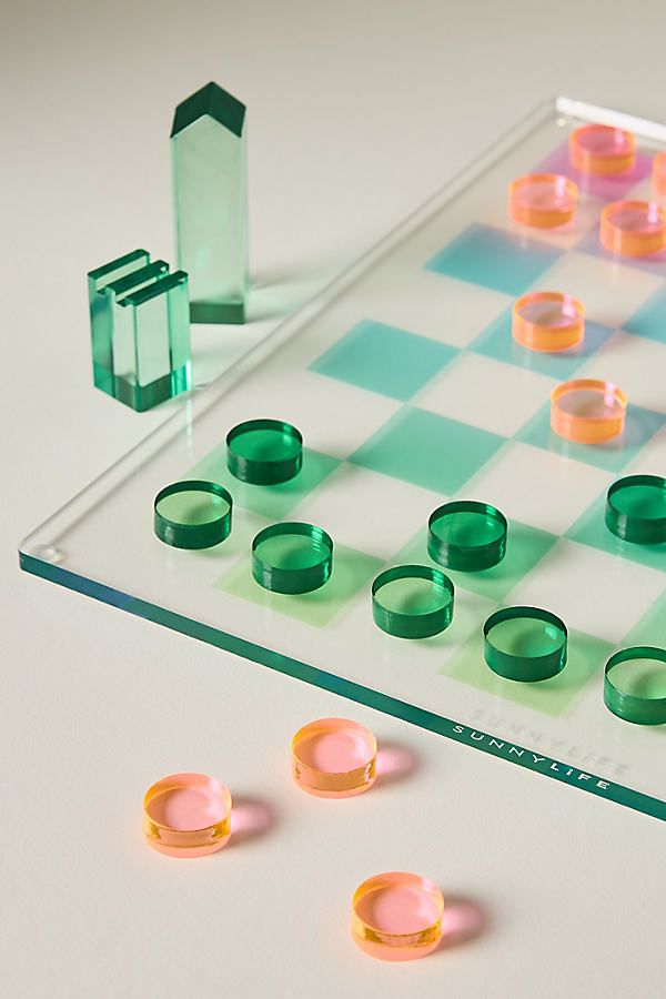 a glass board game with several pieces on it