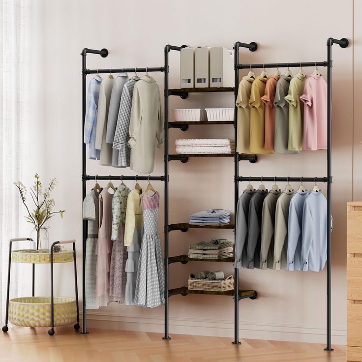 an open closet with clothes hanging on the racks and shelves next to a plant in a potted planter