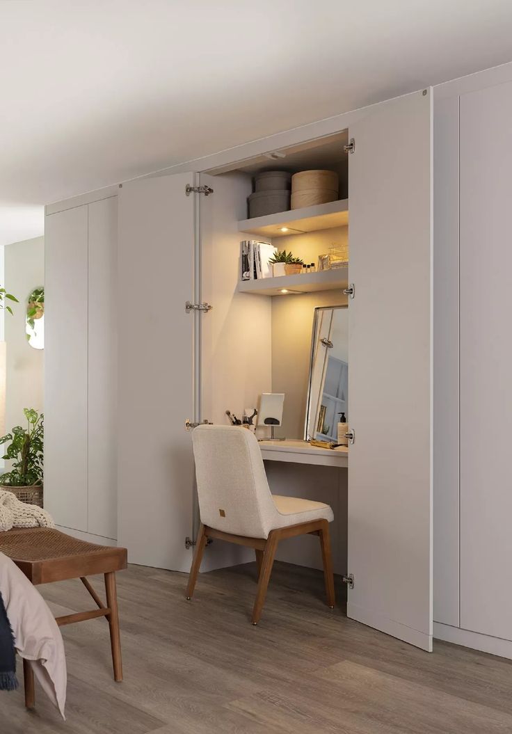 a bedroom with white walls and wooden floors