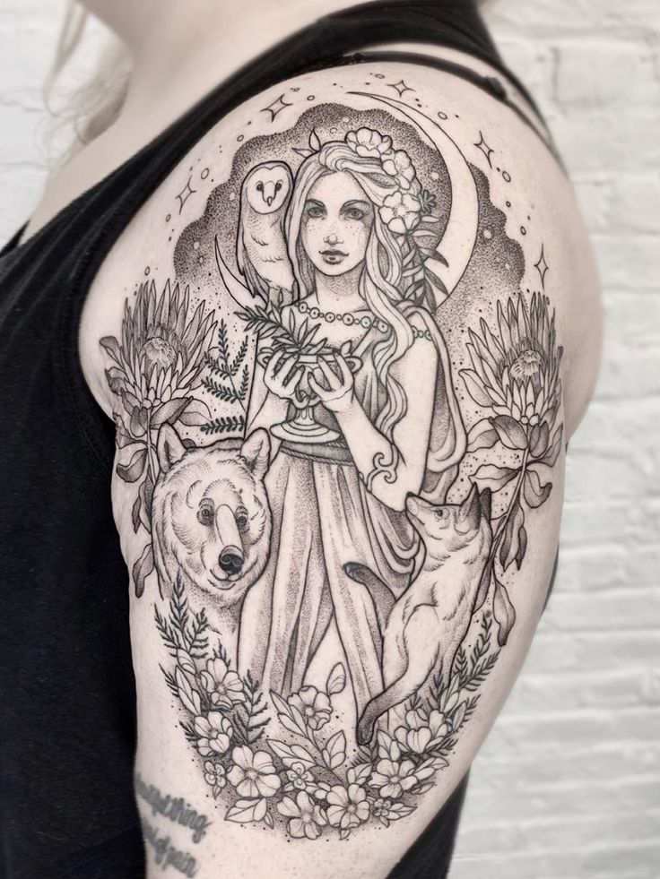 a woman with a tattoo on her arm holding a flower and a bear in front of her