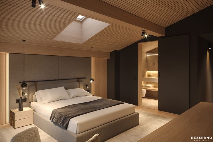 a large bed in a bedroom next to a night stand with lights on the ceiling