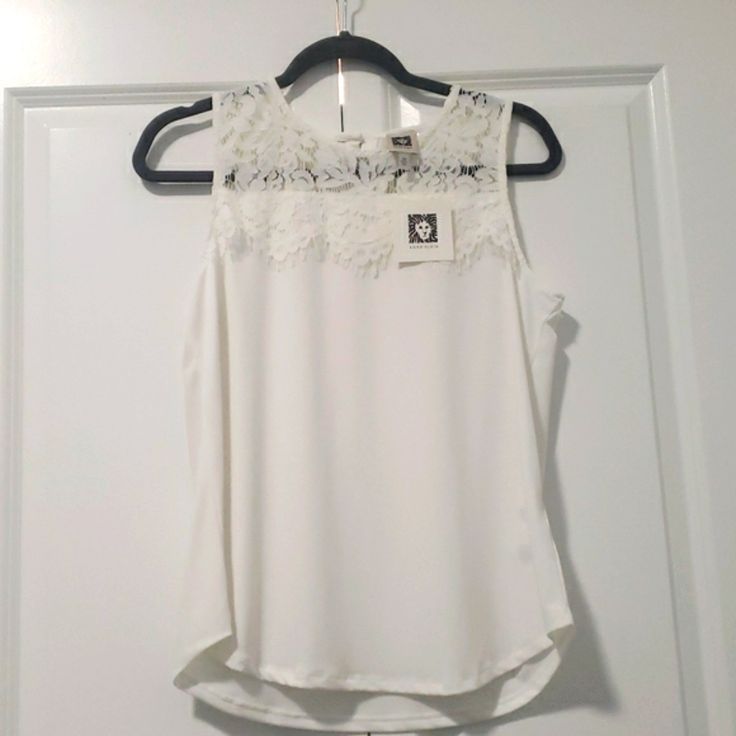 Brand New Anne Klein White Sleeveless Blouse, With A U-Neck And Lace Top. Chic Sleeveless Lace Top Camisole, White Tank Top For Summer Workwear, White Sleeveless Camisole For Spring, White Sleeveless Tank Top For Work, Feminine Lace Sleeveless Tank Top, White Tank Top For Workwear, White Tank Top For Work, Sleeveless Lace Tank Top For Spring, White Feminine Camisole