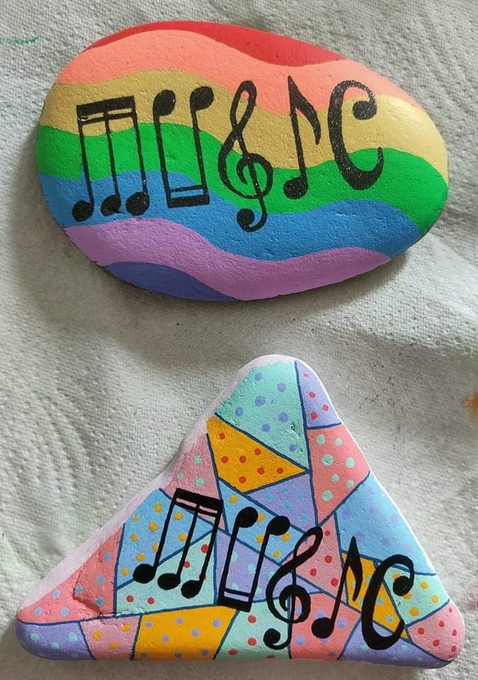 two colorful rocks with musical notes painted on them