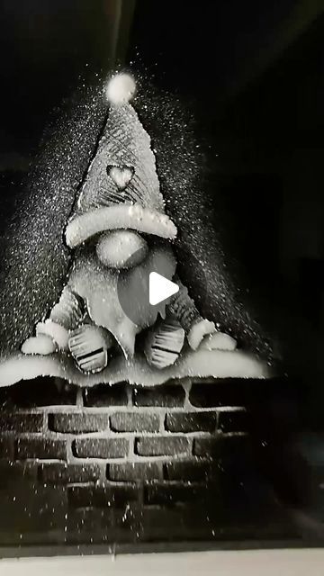 a black and white photo of a santa clause on top of a fire hydrant