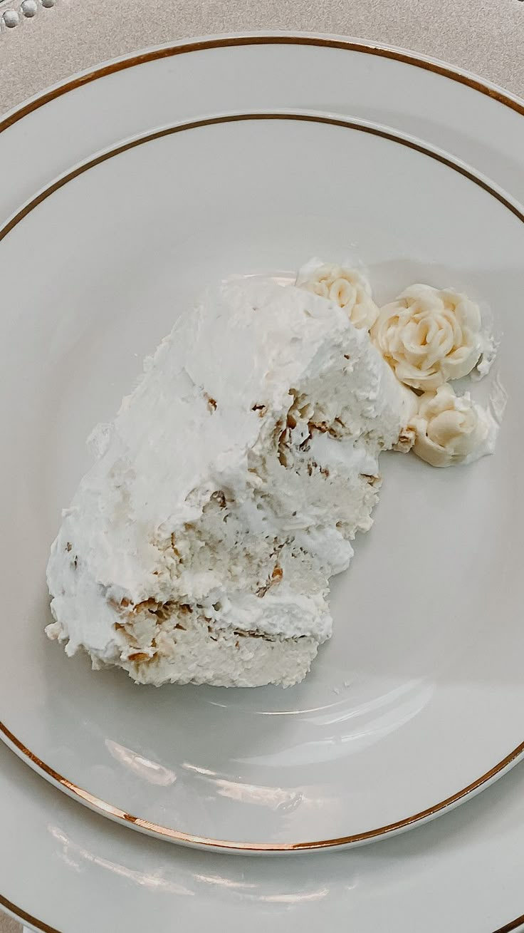 a piece of cake sitting on top of a white plate with gold trim around it