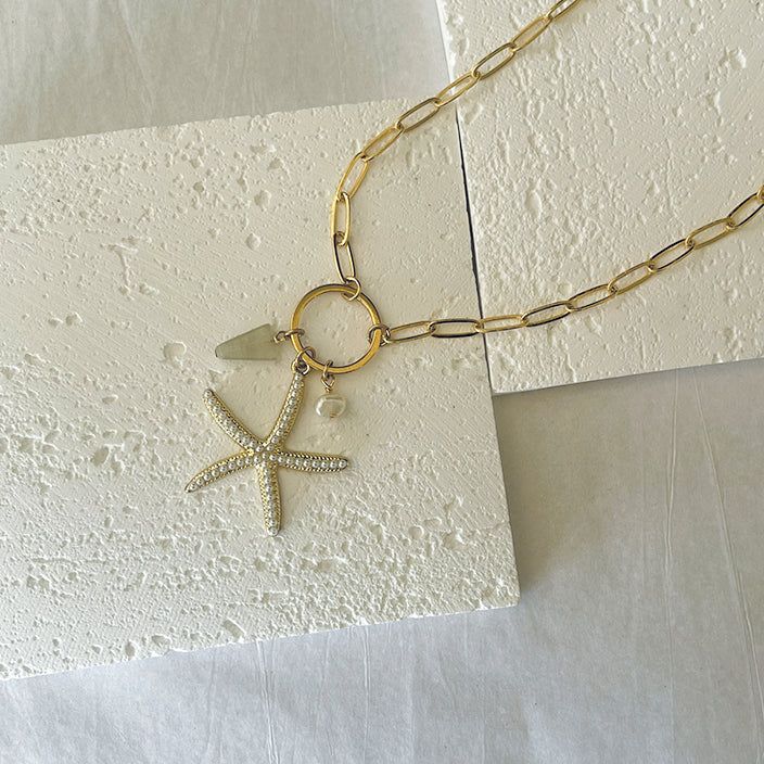 his gold and chunky charms necklace features a starfish made of pearls charm with a tiny freshwater pearl and light green glass stone hanging together on a circle connector.A fun summery charms necklace is great as a beach accessory and a unique gift to someone special or treat yourself with a statement piece of jewelry for summer.♥ 14k Gold filled chain - Tarnish resistant, Nickel-Free, Hypoallergenic♥ Starfish charm measurement: 30mm♥ Length: 15 inches - 18 inches - choose your length from the menu♥ Beautiful package ready for gifting Gold Charm Necklaces For Vacation, Gold Charm Necklace For Vacation, Star Charm Necklaces For Beach, Star Charm Necklace For Beach, Gold Star Charm Necklace For Beach, Gold Charm Necklace With Star Charm For Beach, Gold Shell Necklace With Starfish Charm For Vacation, Gold Shell Necklace With Starfish Charm, Gold Charm Necklace With Star For Beach