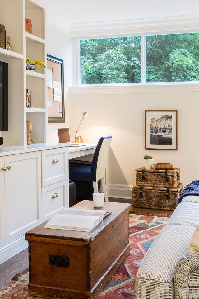 a living room filled with furniture and a flat screen tv on top of a wall