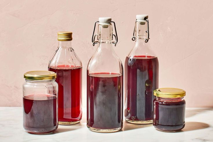 three jars filled with liquid sitting on top of a table