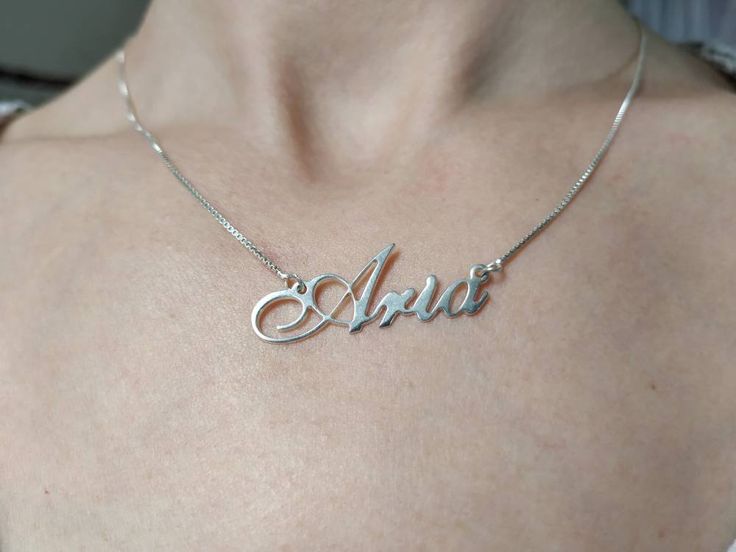 Silver Name Chain - Handwriting Necklace - Cursive Name Charm - English Letters Necklace - Aria . . . . . . . . . . . . . . . . . . . . . . . . . . . . . . . . . . . . . . . . . . . . . . . . . . . . . . . . . . . . . . . . . . . . . . . . . . . . . . . Looking for a thoughtful gift for your loved one? You will love this high quality Silver Name Chain. This is a perfect gift for your girlfriend or wife. Personalize it with her name in a beautiful font. This lovely sterling silver name chain is m Silver Hallmarked Nameplate Jewelry, Classic Silver Name Necklace For Formal Occasions, Formal Sterling Silver Hallmarked Name Necklace, Classic Custom Name Necklace In White Gold, Formal Silver Name Necklace, Formal White Gold Name Necklace, Silver Hallmarked Name Necklace For Anniversary, Silver Name Necklace For Formal Occasions, Classic Sterling Silver Pendant Name Necklace