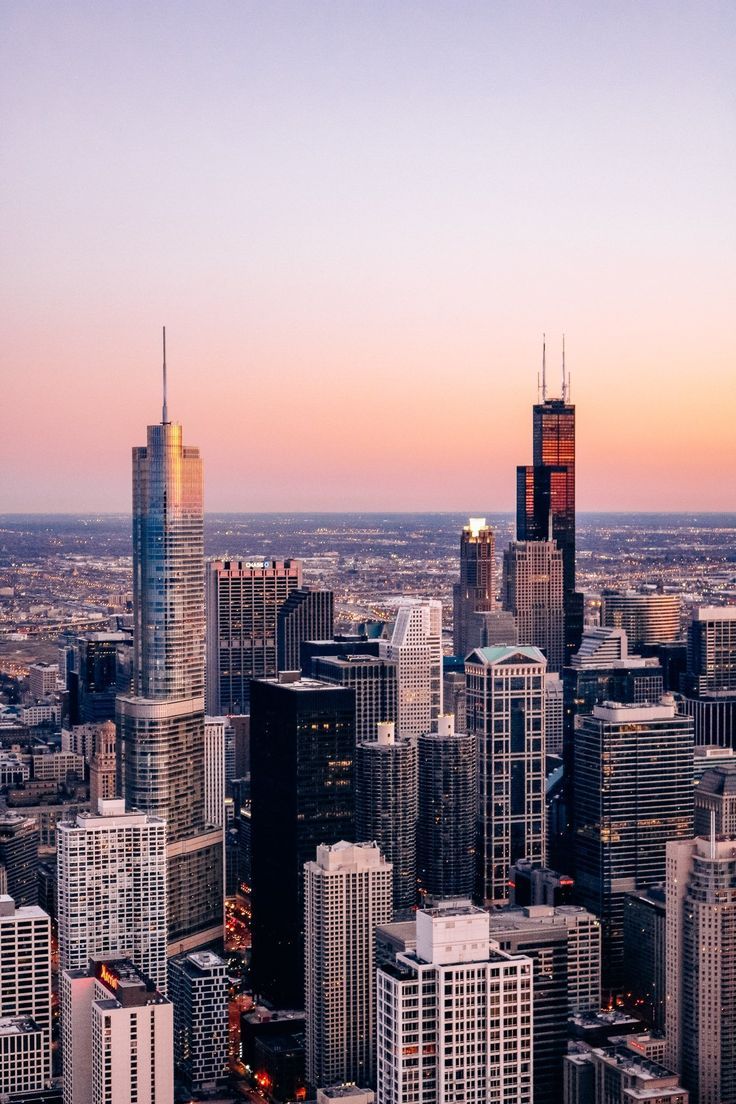 the city is full of tall buildings and skyscrapers at sunset or dawn in chicago, illinois