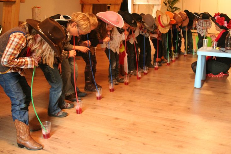 a group of people standing around each other with hats on their heads and poles in front of them