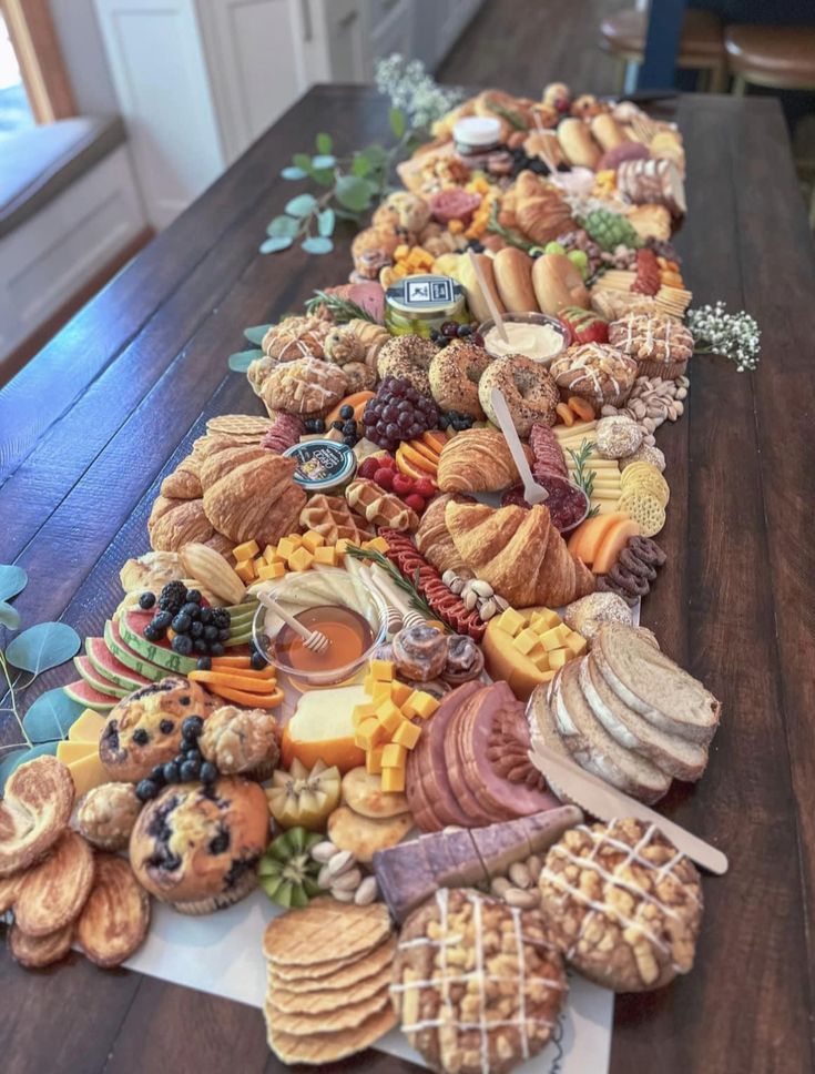 a long table filled with lots of different types of food on top of each other