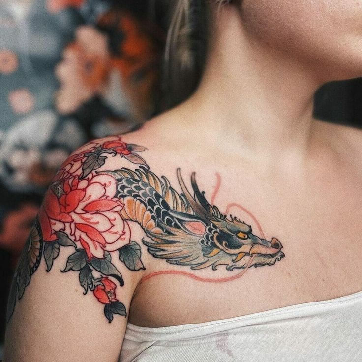 a woman with a dragon tattoo on her shoulder