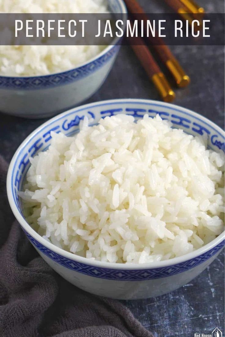 two bowls filled with white rice next to chopsticks on a blue and white cloth