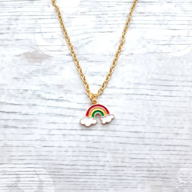 Super cute enamel rainbow charm necklace perfect for any rainbow lover. Great little birthday for family or friends. Would go perfect with matching items which can be found in my store. CHAIN LENGTH: *14inches perfect for children  *16inches perfect for children *18inches *20inches *22inches MARTERIALS: Chain, findings and charms and all gold plated *The enamel rainbow charm measures approximately 2cms long. * green, yellow, red * red, yellow, purple *These can also be personalised with initial charms which can be picked from the menu. The initial charms are gold plated and measure 1cm. ☆☆The necklace comes presented in a gift bag but boxes and gift wrapping can also be purchased from my store.☆☆ If you have any questions or custom orders please feel free to message me. Iris Cabin, Fairytale Bracelet, Boyfriend Initials, Initial Birthstone Necklace, April Birthstone Necklace, Unicorn Bracelet, Pride Necklace, Crescent Moon Jewelry, March Birthstone Necklace