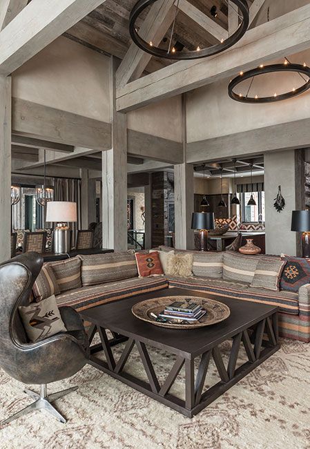 a living room filled with lots of furniture next to a fire place in a building