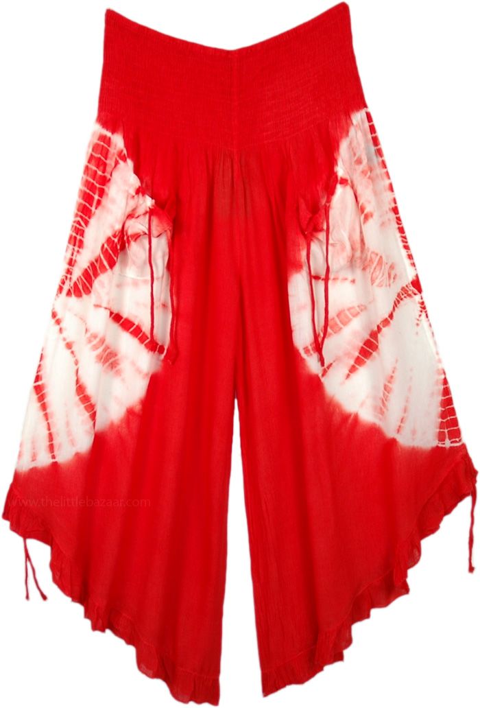 A cropped wide-leg pant. features smocked elastic waistband, 2 front tie pockets, and tie ruffle leg opening. A chic pair of wide-leg culotte pants in red with a white tie-dye that goes around the middle of the pants, back, and front. This style is totally fresh and you will be ahead of fashion. The front pockets come with a functional tie-up string that gives it a boho look. Similar functional tie-ups are attached at the bottom of these pants and can be pulled to make the leg opening higher. Th Red Drawstring Bottoms For Summer, Red Drawstring Bottoms For Vacation, Bohemian Wide-leg Pants With Drawstring, Red Drawstring Summer Bottoms, Summer Wide Leg Pants With Drawstring, Bohemian Wide-leg Drawstring Pants, Red Tie-side Summer Bottoms, Red Tie-side Bottoms For Summer, Summer Parachute Pants With Drawstring