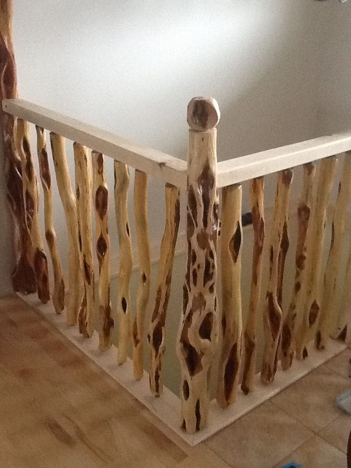 a stair rail made out of wood sticks