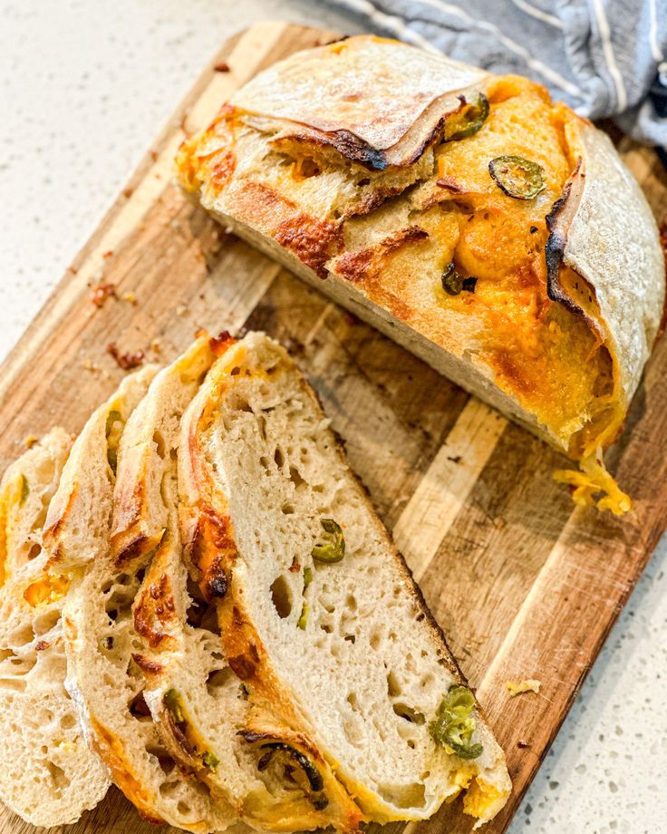 a wooden cutting board topped with sliced bread