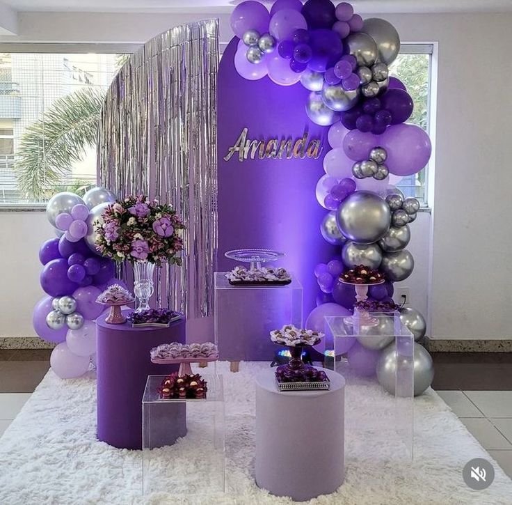 purple and silver balloons are on display at an event