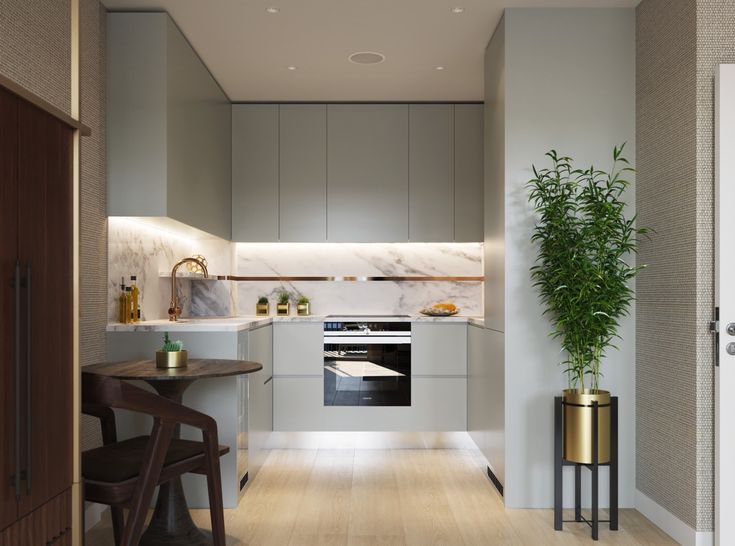 a modern kitchen with white cabinets and wood floors