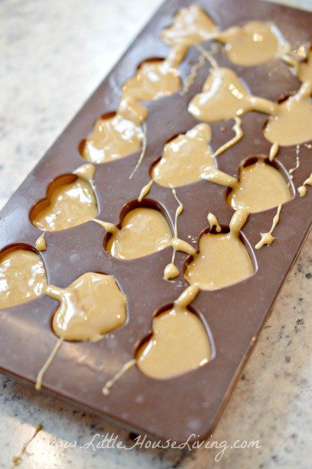 a chocolate bar with peanut butter hearts on it sitting on a counter top, ready to be eaten