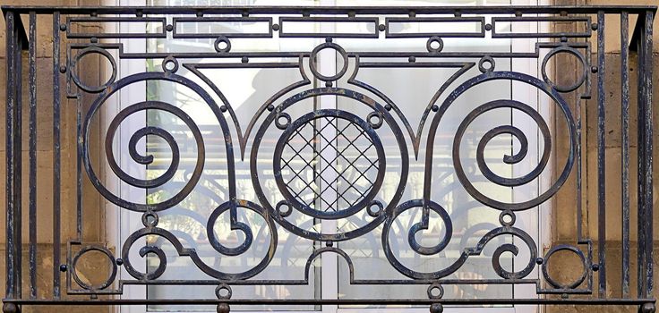 an iron gate is shown in front of a window