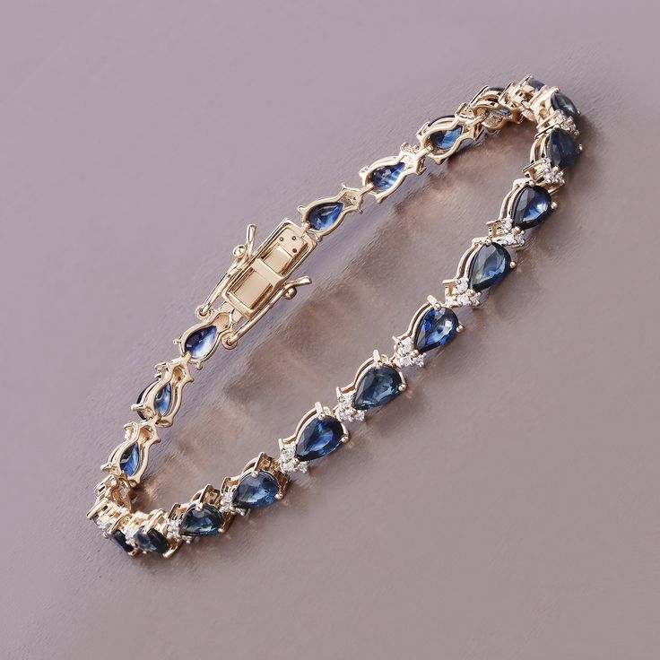 Real Blue Sapphire and Diamond Tennis Bracelet, 14k Gold Sapphire Bracelet, Genuine Blue Sapphire Pears and Diamond Gold Bracelet for Women Experience the allure of this 8.82 carat genuine pear blue sapphire tennis bracelet, crafted in 14K yellow gold. The bracelet features 0.50 carats of genuine round white diamonds, adding a touch of brilliance. This exquisite piece celebrates the September birthstone, offering a blend of classic beauty and modern elegance. Product Details:  14K Yellow Gold Item Type: Bracelet Gross Wt: 10.85 Gemstone Wt: 8.82 ctw Diamond Wt: 0.50 ctw Total Stone Wt: 9.32 ctw Finish: Fine Finish Product Style: Tennis Bracelet Chain Type: No Chain Type Clasp: Box With Tongue And Safety Clasps Total Qty Of Stones: 84 Height: 4.06 MM Width: 4.83 MM Length: 7.00 Inches Prima Luxury Blue Sapphire Bracelets, Elegant Blue Bangle Gold Bracelet, Blue Gold Bracelet For Gift, Fine Jewelry, Fine Jewelry Blue Gold Bracelet For Gift, Blue Gold Bracelet For Gifts, Blue Jubilee Tennis Bracelet Fine Jewelry, Blue Cubic Zirconia Tennis Bracelet Fine Jewelry, Blue Sapphire Bracelets For Anniversary, Formal Sapphire Bracelet