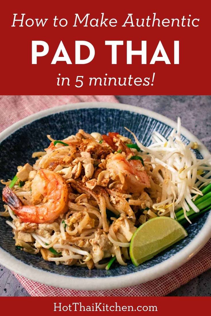 pad thai noodles with shrimp and vegetables in a blue bowl