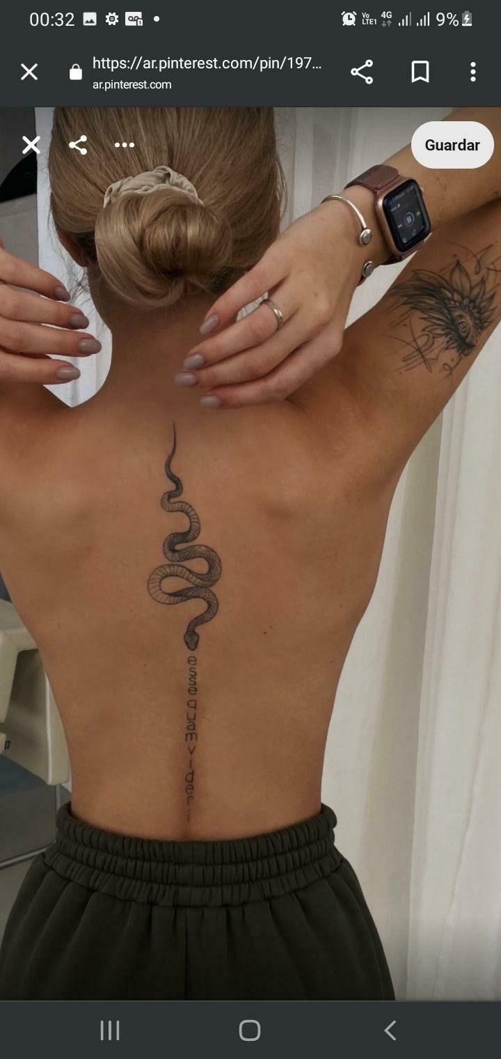 a woman with a snake tattoo on her back