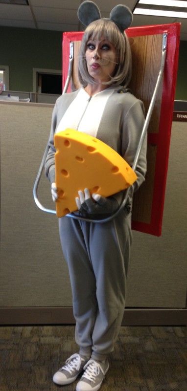 a woman in mouse ears holding a cheese slice