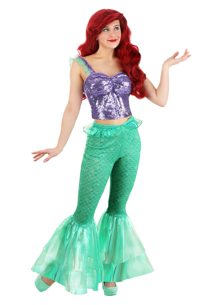 a woman in a mermaid costume posing for the camera