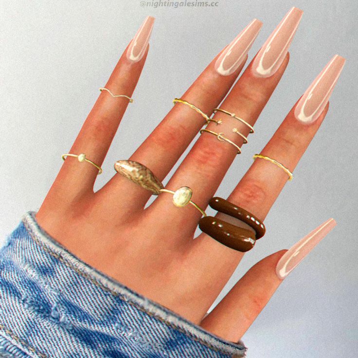 a woman's hand with five different rings on it and one ring in the middle