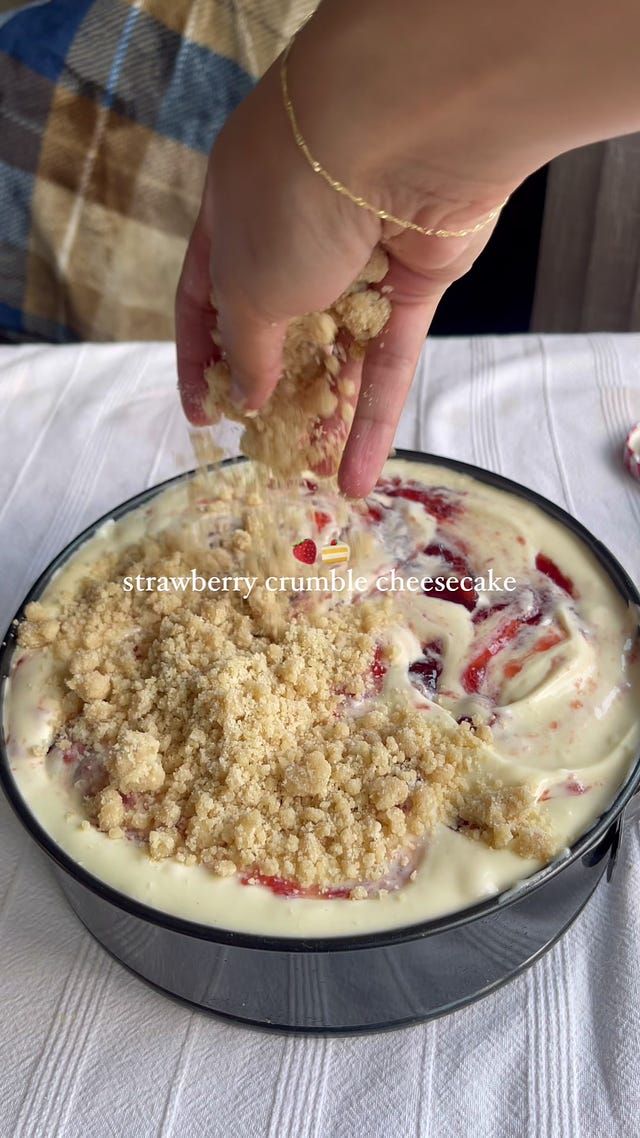 a person is dipping some food into a pan with white sauce and crumbs