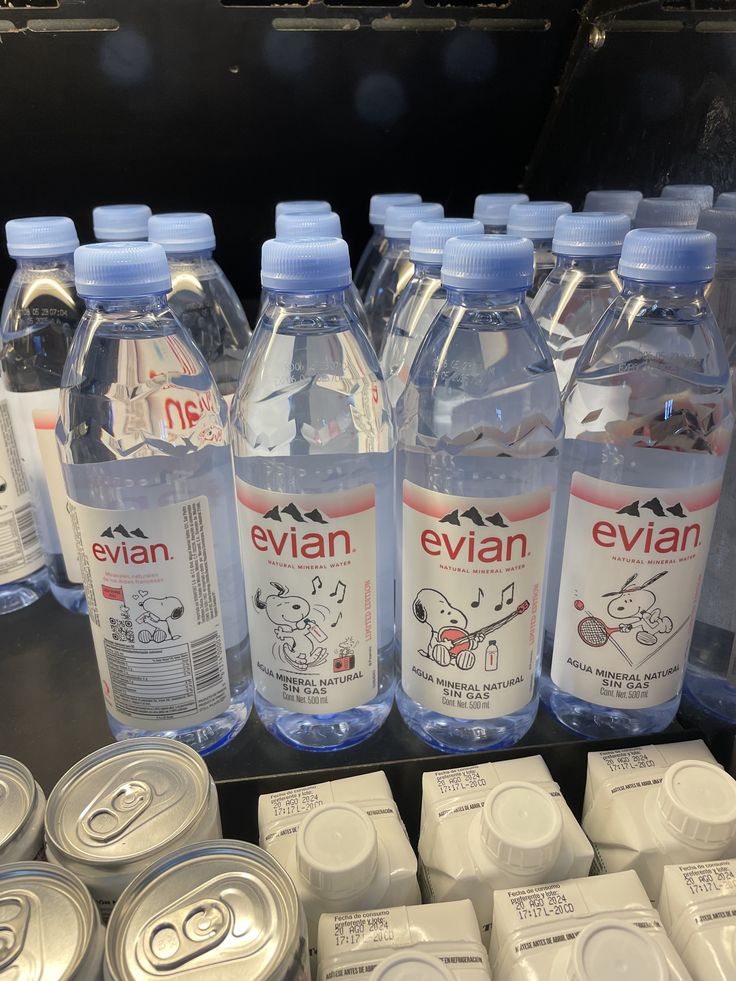 several bottles of evian water are on display